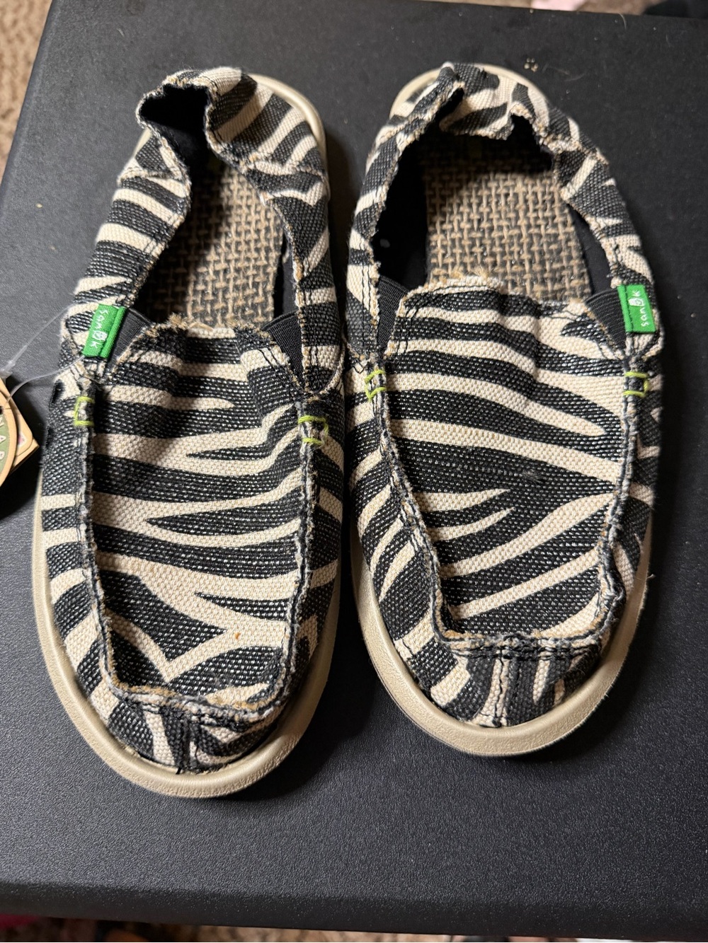 Sanuk Women's Zebra Print Slip-On Shoes in Black and Cream